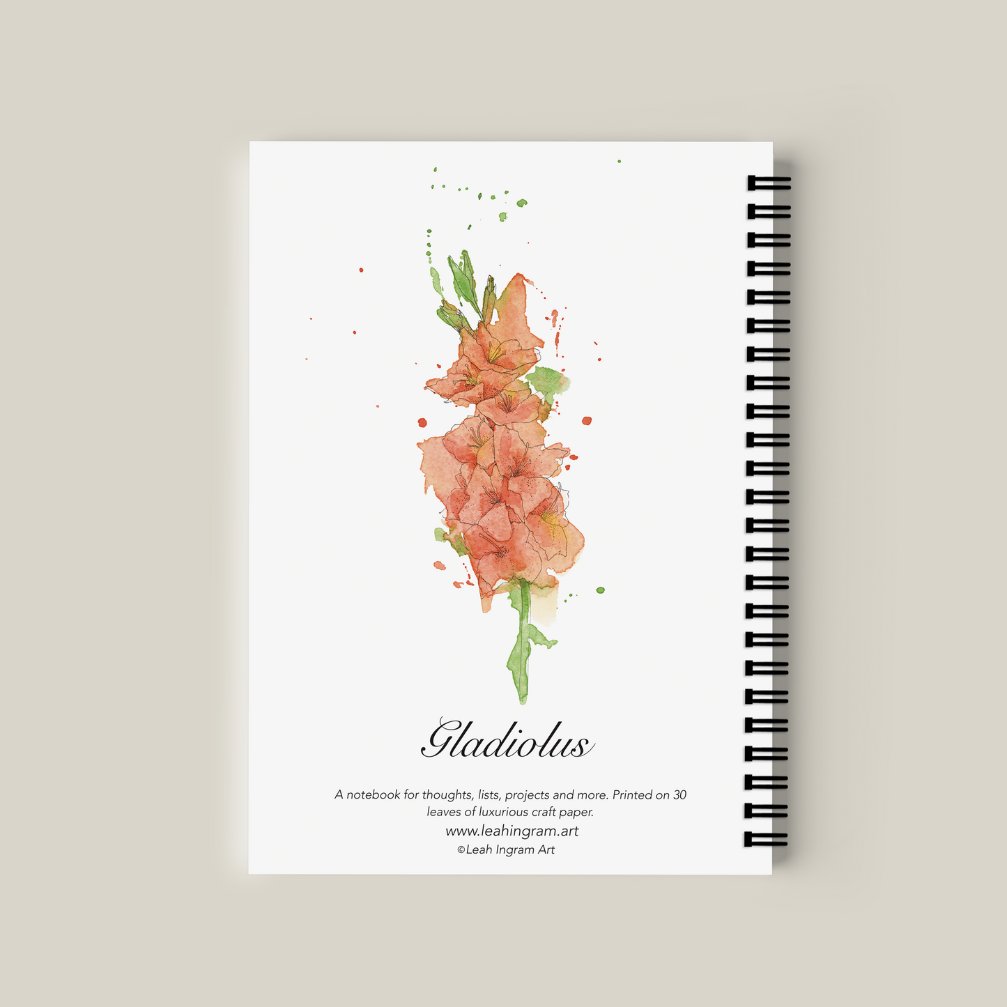 Notebook with floral design on the cover against a beige background