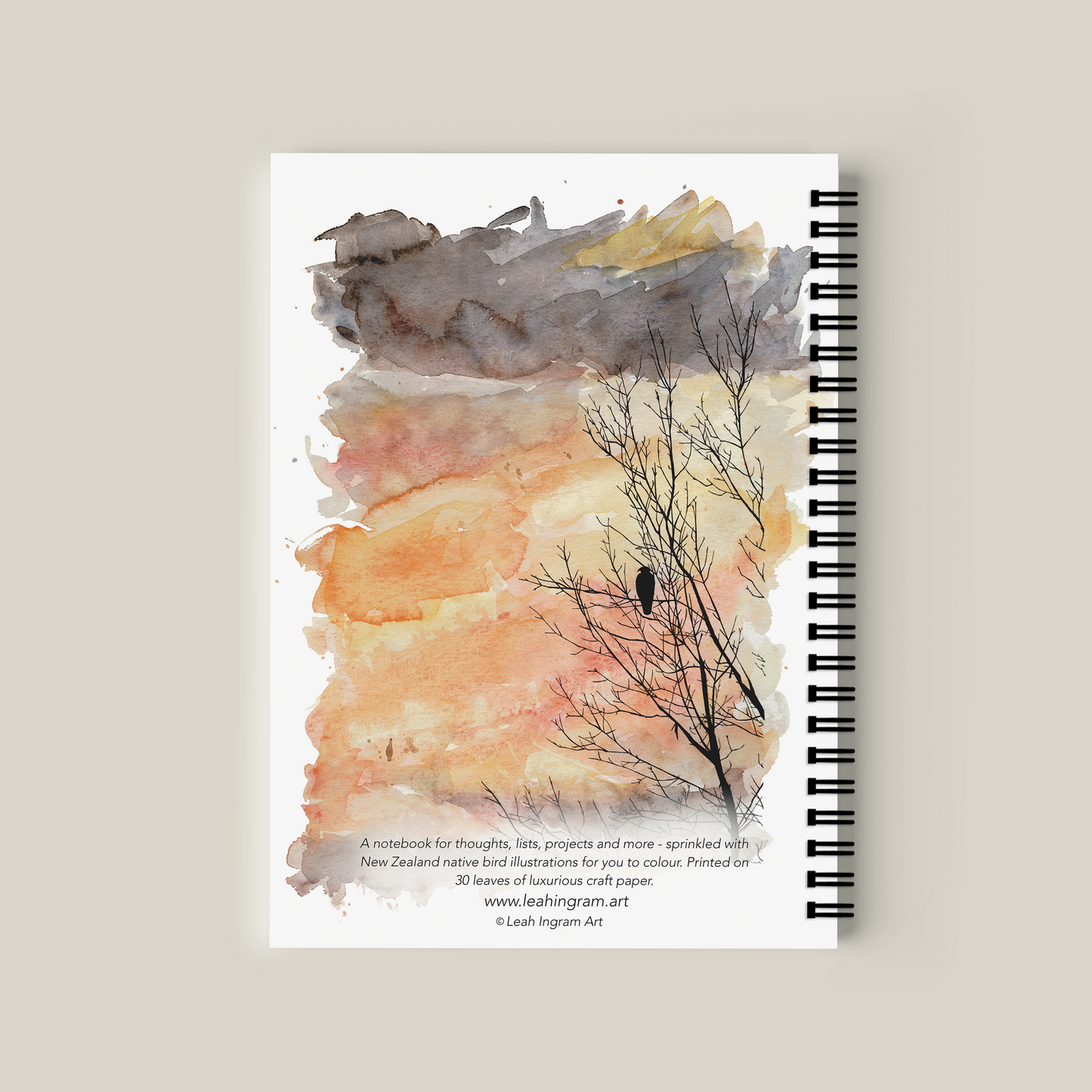 Notebook with artistic cover design on a beige background