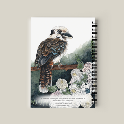 Notebook with a bird illustration on the cover against a beige background