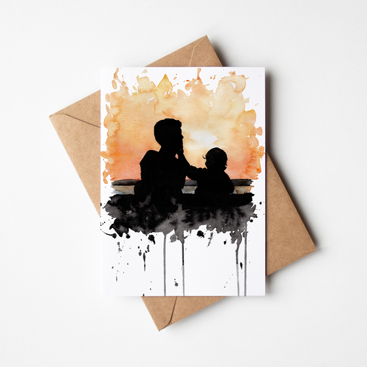 Greeting card with silhouette of a father and child on watercolor background, accompanied by a brown envelope.